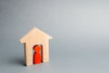 Miniature wooden house with a tenant inside. The concept of renting a house or apartment. Affordable housing. Mortgage. Home loan Royalty Free Stock Photo