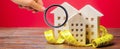 Miniature wooden houses and measuring tape. Home appraisal and property valuation concept. Housing construction, repair and Royalty Free Stock Photo