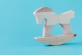 Miniature wooden rocking horse for little doll on white backgrou