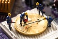 Miniature worker cutting bitcoin , halving concept Royalty Free Stock Photo