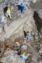 Miniature worker with a hammer working in a quarry Royalty Free Stock Photo