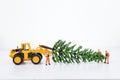 Miniature worker moving model tree and front loader truck Royalty Free Stock Photo