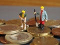 Miniature worker people stand on Euro coins. Business and idea c Royalty Free Stock Photo
