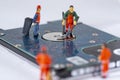 Miniature Workers cleaning a broken hard drive and recycle it Royalty Free Stock Photo