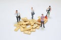 Miniature Workers Managing Stack Of Metallic Gold Bars Royalty Free Stock Photo