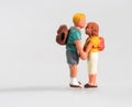 Miniature young couple in love holding hands