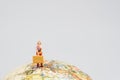 Miniature young lady with camera holding baggage standing on Europe map on globe with white background copy space using as Europe