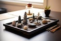 miniature zen garden with perfectly balanced stones on a desk