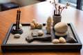 miniature zen garden with perfectly balanced stones on a desk