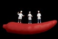 Miniatures of cooks and red hot chili pepper