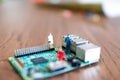 miniatures of people on a green electronic board. Relationship between man and technology, abstract concept with miniature Royalty Free Stock Photo
