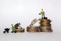 Miniatures on stacks of money Royalty Free Stock Photo