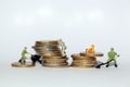 Miniatures on stacks of money Royalty Free Stock Photo
