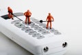 Miniatures of workers fixing a cordless phone Royalty Free Stock Photo