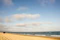 Minibus Car going far away at yellow sand seaside blue sky white Royalty Free Stock Photo