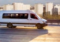 Minibus goes on the city street Royalty Free Stock Photo