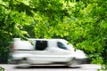 Minibus in motion on a forest road