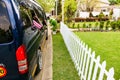 Minibus taxi van parked outside a house in a wealthy neighborhood