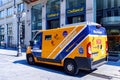 Minibus yellow-blue Mondialpol Milano security service near the Che Banca doors in Milan