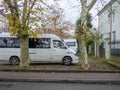 Minibuses at the old house. Yard in Batumi. Parked vehicles