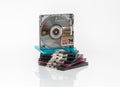 A minidisc stands vertically on a stack of other minidiscs on a white background