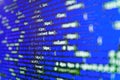 Minificated web development javascript code close up in sunset rays. Developer working on websites codes in office. Web Royalty Free Stock Photo