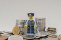 Minifigure of policeman on a pile of coins