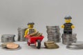 Minifigures of bank robbers stealing money. Thieves carrying coins Royalty Free Stock Photo