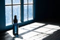 Minimal abstract black background for product presentation. Organic drop diagonal shadow and rays of light from window on a blue