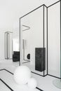 Minimal black and white room with abstract circular marble and metal line reflect in mirror in natural light setting scene -