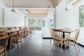 Minimal bread cafe decorating with white wall and wooden chairs. Warm, cozy and comfortable