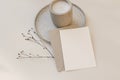 Minimal Christmas or autumn stationery. Closeup of blank greeting card, invitation mockup with envelope. Candle in