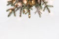 Minimal Christmas decor made of fir branches and golden light garland, copy space Royalty Free Stock Photo