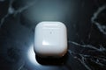 White wireless earbuds case on dark marble with matte finish, plain and unmarked Royalty Free Stock Photo