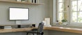 Minimal and comfortable home working room with computer corner desk against the window Royalty Free Stock Photo