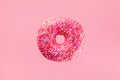 Minimal composition of flying pink donut. Sweet doughnut on pastel background