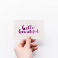 Minimal composition with girl`s hand holding card with inspirational quote Royalty Free Stock Photo