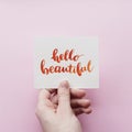 Minimal composition with girl`s hand holding card with inspirational quote Royalty Free Stock Photo