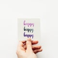 Minimal composition on a white background with girl`s hand holding card with word Royalty Free Stock Photo