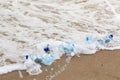Minimal concept of environmental pollution, plastic bottles lie on the sea beach, near the water Royalty Free Stock Photo