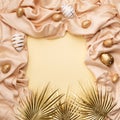 Minimal concept palm leaves with a golden easter eggs on a silk or saten fabric against pastel background with copy space Royalty Free Stock Photo