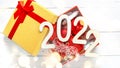 Christmas composition of present in Golden box and 2022 numbers on White Royalty Free Stock Photo