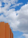 Minimal corner of modern building facade against blue cloudy sky. Minimalistic architecture detail. minimal urban background. Royalty Free Stock Photo