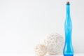 Minimal elegant composition with rattan balls and blue bottle