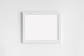 Minimal empty square white frame picture mock up hanging on white wall