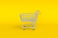 Minimal empty top view mini shopping cart or trolley shopping on yellow background, concept shopping in supermarket. Royalty Free Stock Photo