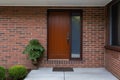 minimal exterior shot, wooden front door in brick wall Royalty Free Stock Photo