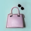 Minimal fashion concept woman accessories - trendy summer sunglasses and glamour pink handbag