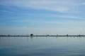 Minimal fisherman hut, bamboo and wooden stick structure fishery farm above sea wetland with clear sky background