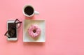 Minimal flatlay with overhead coffee, donut and smartphone
